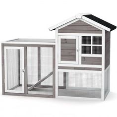 a white and gray chicken coop with two doors, one door open and the other closed