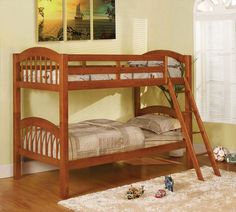 a wooden bunk bed sitting on top of a hard wood floor next to a window