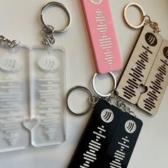 four different types of keychains are on display with each other in the same row