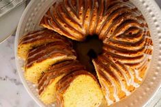 a bundt cake with icing on a white plate