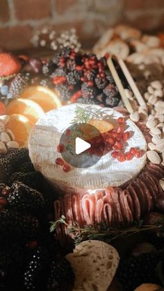 a cake sitting on top of a table covered in fruit