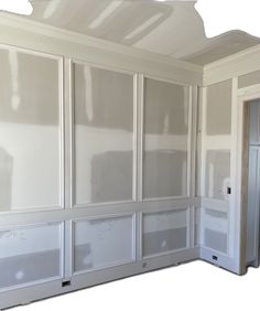 an empty room with white paint on the walls and doors in place to be painted