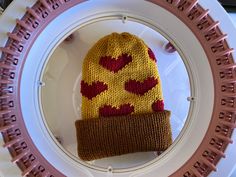 a knitted hat sitting on top of a white plate