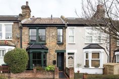 two story brick house with green door and windows