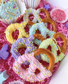 assorted decorated donuts and cupcakes in a box