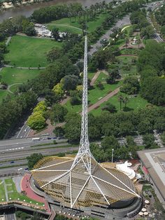 an aerial view of a large radio tower in the middle of a green park area