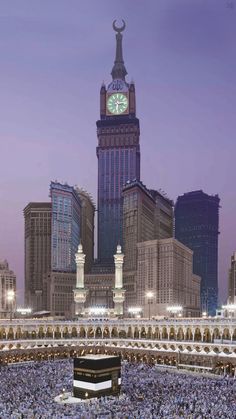 the kabab is surrounded by tall buildings in the middle of the city at night