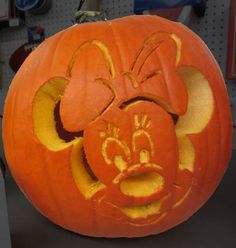 a mickey mouse pumpkin carved to look like it's smiling