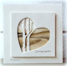 a white card with a tree cut out of it's heart and the words growing together