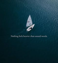 an aerial view of a sailboat in the ocean with a caption that reads nothing feels beaver than unsailed words