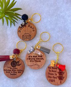 four wooden keychains with different designs on them, one is saying it's not you i worry about