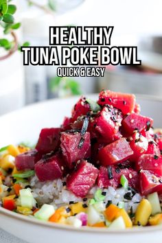 healthy tuna poke bowl with rice and vegetables in a white bowl next to a potted plant