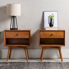 two wooden nightstands sitting next to each other on top of a carpeted floor