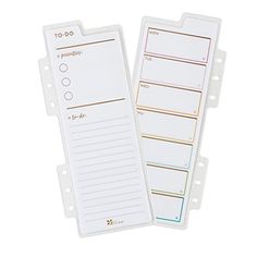 two white notepads sitting next to each other