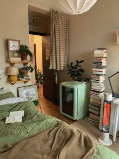 a bed room with a neatly made bed and lots of books