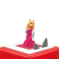 there is a small toy on top of a red box that has a shark in it