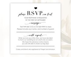 a white wedding card with the words rsvp on it and a black heart