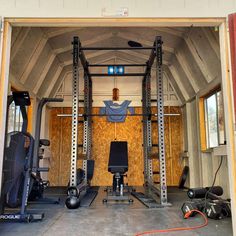 the inside of a home gym with equipment