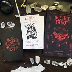 two books sitting on top of a table next to crystals