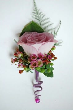 a pink rose and green leaves on a white background with the word love spelled out