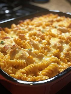 a casserole dish with pasta and chicken in it on a stove top oven