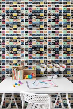 a white table sitting in front of a colorful wall