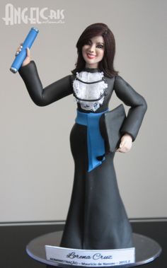 a woman figurine holding a blue object in her hand