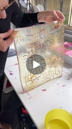 a woman is working on an art project