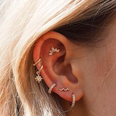 a close up of a person with ear piercings