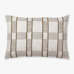 a white and brown striped pillow on a white background