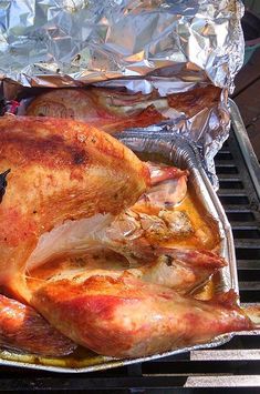 a roasted chicken sitting on top of a grill