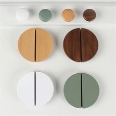 four different colored circles are arranged on the wall, one is white and one is brown