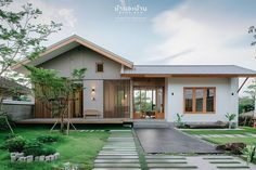 a small house is shown in the middle of a grassy area with stepping stones on the ground