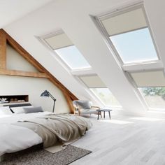 an attic bedroom with red and white shades on the windows, bed in foreground