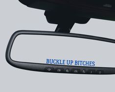 the side mirror of a vehicle with buckle up pitches written on it