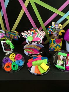 the table is set up with different items for arts and crafts, such as rubber bands