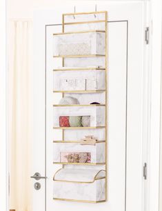 a white door with a gold shelf filled with items