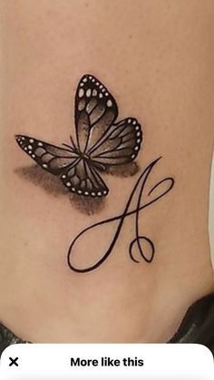 a woman's lower back tattoo with two butterflies on her stomach and the letter a