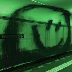 the shadow of a person on a subway wall