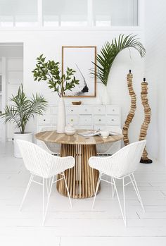 a dining room table with white chairs around it