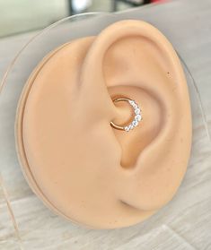 a close up of a fake ear with a ring in it's middle on a table