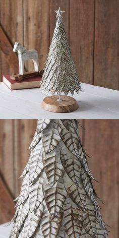 a small white tree sitting on top of a table next to a wooden horse figurine