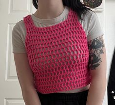 This is a cute pink mesh tank top, crocheted by myself with acrylic yarn that I got from the thrift store! Pink Open Knit Crochet Top For Spring, Sleeveless Crochet Lace Knit Crop Top, Stretch Pink Crochet Top, Stretch Crochet Top In Pink, Pink Stretch Crochet Top Casual Style, Pink Crochet Top For Spring, Spring Pink Crochet Top With Knit Fabrication, Summer Knit Pink Crop Top, Pink Knit Crop Top For Summer