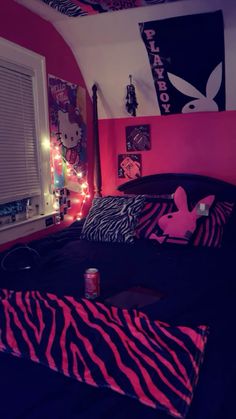 a bedroom decorated in pink and black with zebra print on the bedspread, neon lights and posters