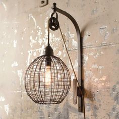 an old fashioned light fixture hanging on the wall