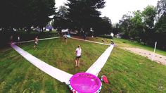 people playing frisbee in the park on a cloudy day with no one around