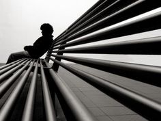 a man sitting on top of a wooden bench next to a metal fence with the caption valentine's day