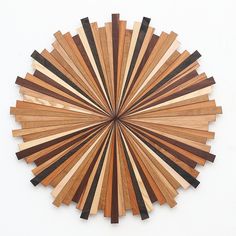 a circular piece of wood that has been cut into smaller pieces and arranged in the shape of a sunburst