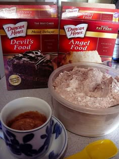 two boxes of devil's kitchen angel food next to a cup and saucer