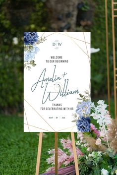 a wedding welcome sign with blue and white flowers